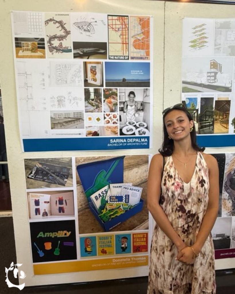 Graduating architecture student standing beside her senior thesis board at a student work exhibition