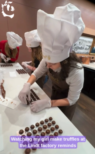 Teen in a chef's hat and apron rolling chocolate truffles at a Lindt chocolate factory workshop