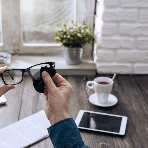 man-cleaning-glasses-PKAQUKX