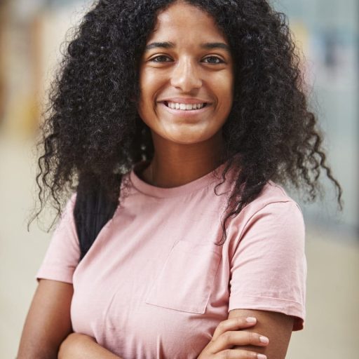 portrait-of-female-student-standing-in-college-PTK57Z8